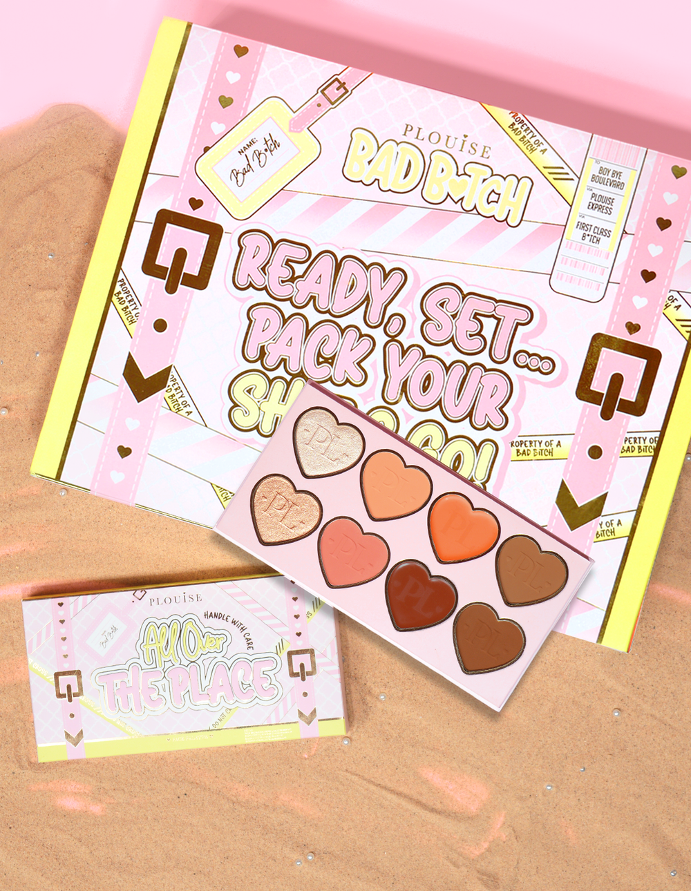 P.Louise All Over The Place Face Palette Balení a produkt vystavený s odstíny pánve ve tvaru srdce v různých barvách na pískovém loži.