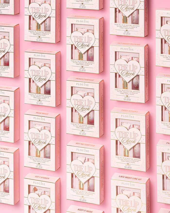 A repeating pattern of pink and white P.Louise 'The Lip Check' lip kits arranged in a grid on a solid pink background.